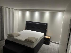 a bed with a black headboard in a room at Villa luxueuse et Moderne avec piscine ! in Béziers +36 photos