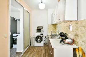 a kitchen with a washing machine and a washer at 2BR Spacious Apartment in Varna City