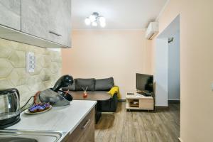 a kitchen and a living room with a couch at 2BR Spacious Apartment in Varna City +6 photos