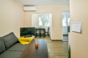 a living room with a couch and a table at 2BR Spacious Apartment in Varna City