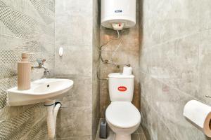 a bathroom with a toilet and a sink at 2BR Spacious Apartment in Varna City