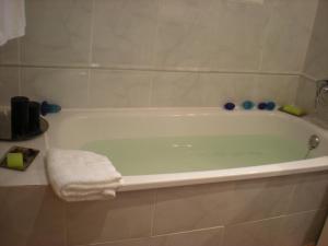 a bathroom with a bath tub with a towel at Casco Viejo Candeleda in Candeleda +18 photos