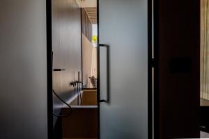 an open door to a bathroom with a sink at Pnoe Breathing Life - Adults Only in Karteros