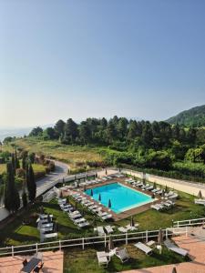 an aerial view of a swimming pool with lounge chairs and a resort at Casa ARMANDA 2 in Rivalto