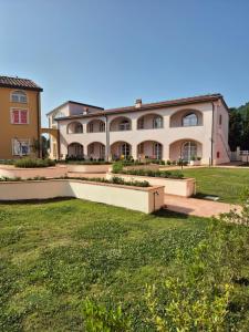 a large building with a lawn in front of it at Casa ARMANDA 2 in Rivalto