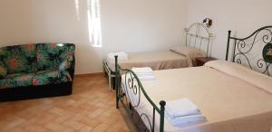 a small room with two beds and a chair at Il Nasciolo in Arrone +57 photos