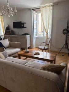 una sala de estar con un sofá y una mesa en L'ideal, en Vannes