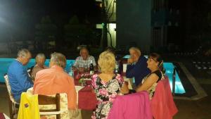 a group of older people sitting at a table at Erol Motel in Orhaniye