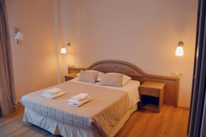 a bedroom with a bed with two towels on it at Art Pythia Boutique in Delphi +87 photos