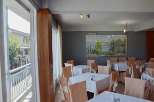 a restaurant with tables and chairs and a large window at Art Pythia Boutique in Delphi