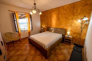 a small bedroom with a bed and a window at Baia Marina Suite with private jacuzzi in Balestrate