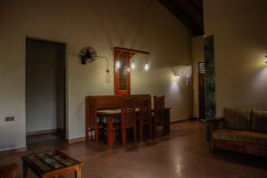a living room with a table and some chairs at The Hidden Heaven in Diyatalawa