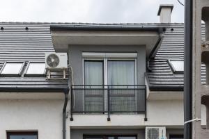 a building with a balcony with a fan at Big Suit for 4 Adults and 2 Children under 14 years in Hajdúszoboszló