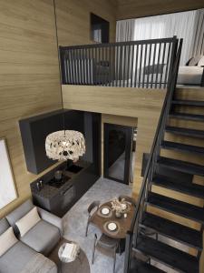 a living room with a staircase and a couch at Levin Lyhty Bea by Hilla Villas in Kittilä