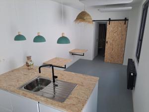 a kitchen with a sink and a counter top at Chambre luxe in Liège