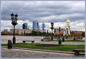 a park with benches and street lights and a city at ApartLux Park Pobedy 2 in Moscow