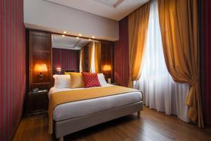a bedroom with a bed and a large window at Atlante Garden Hotel in Rome