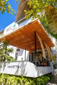 a restaurant with a canopy in front of a building at Agua de Luna Hotel Boutique, San Pancho Nayarit in San Francisco