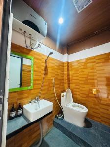 a bathroom with a white toilet and a sink at Local Homestay Du Gia in Ha Giang