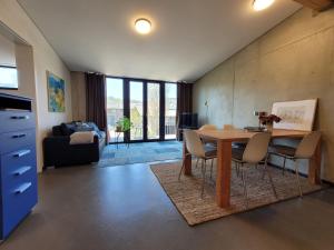 a living room with a table and chairs and a couch at Hof Gasswies in Klettgau