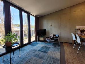 a living room with a television and a table and chairs at Hof Gasswies in Klettgau