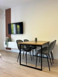 a dining room with a wooden table and chairs at Savo Apartments in Tivat