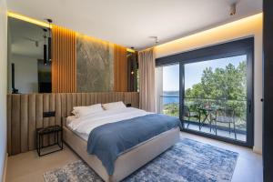 a bedroom with a large bed and a large window at Villa Blue Sunset in Brsečine +44 photos