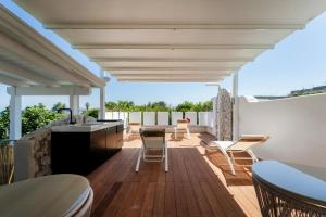 a patio with a sink and a table and chairs at Oikos - Charm & Relax Procida in Procida