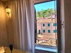 a window with a view of a building at La Maisonnette in Rio Marina +19 photos
