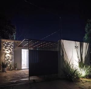 a house with a gate at night at Mini House 01 in Naviraí