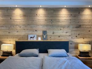 a bedroom with two beds and two lamps at Spacious 3 Room Apartment - Family-Friendly - Central Leukerbad - Great Views in Leukerbad +25 photos