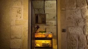 a room with a mirror and a table with a bowl at Iris Cave Cappadocia in Ortahisar +76 photos