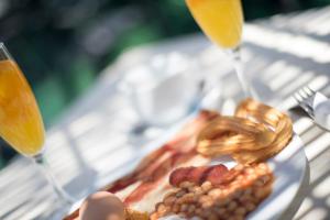 a plate of food and two glasses of orange juice at Hotel Toboso Chaparil in Nerja