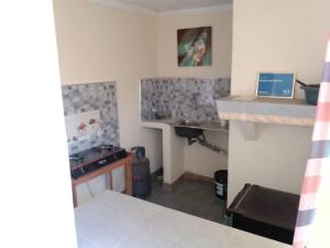 a small kitchen with a sink and a counter at Recanto do Meu Tio in Chimoio