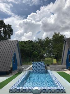 Family Cottage Beseri في كانجار: كرسي أزرق يجلس في منتصف حمام السباحة