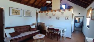 a living room with a couch and a table at Casa las estrellas in Garafía