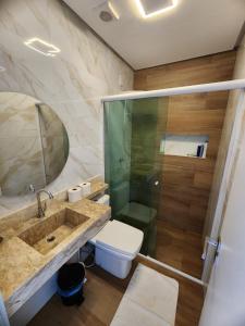 a bathroom with a sink and a toilet and a shower at Casa Odara - Lençóis Maranhenses - Barreirinhas MA in Barreirinhas