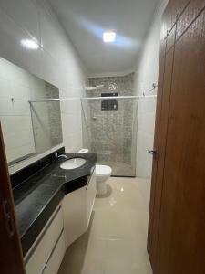 un bagno con lavandino, WC e doccia di VISTA MAR 3 apt6 a Porto Seguro Altre 3 foto