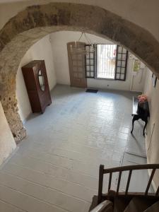 an attic room with a stone floor and a door at Appartement de l'îlot des Chaudronniers in Béziers +4 photos