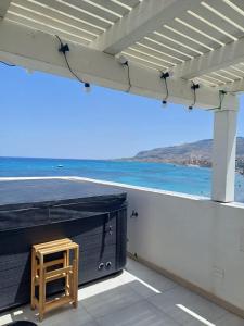 a stool on a roof with a view of the ocean at GREEN FRESH in Trapani