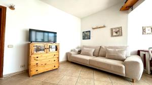 a living room with a couch and a flat screen tv at Welooveyou Honey in Costa Calma