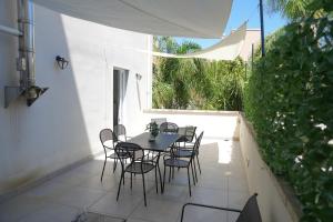 a table and chairs on a patio with a window at Lecce Diamond - 200mq in centro città con terrazza privata in Lecce