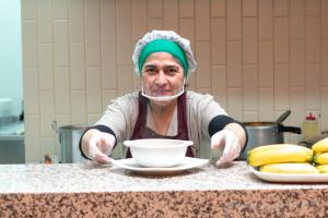 a man sitting at a counter with a bowl at Hotel Quinta del Café in Fredonia