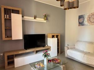 a living room with a tv and a couch at casa Martina - LuxRental Apartments in Pescara