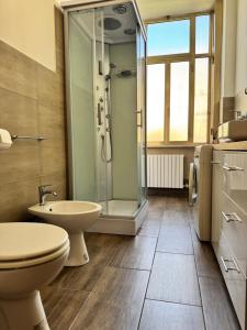 a bathroom with a shower and a toilet and a sink at casa Martina - LuxRental Apartments in Pescara +15 photos