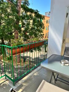 a balcony with a table and a bench and a tree at casa Martina - LuxRental Apartments in Pescara