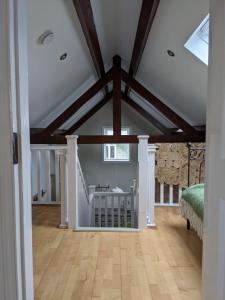a living room with a vaulted ceiling with wooden beams at Arrigle Cottage in Kilkenny