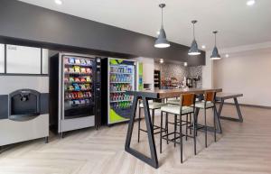 a drink station with a bar and a refrigerator at Extended Stay America Premier Suites - Bradenton in Bradenton