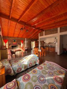 a large room with two beds and a kitchen at Nuestro Chalet in La Falda +47 photos
