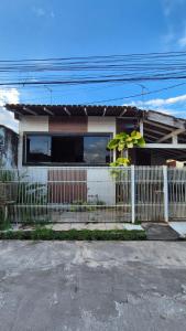 una cerca blanca frente a una casa en Casa COP30, en Ananindeua